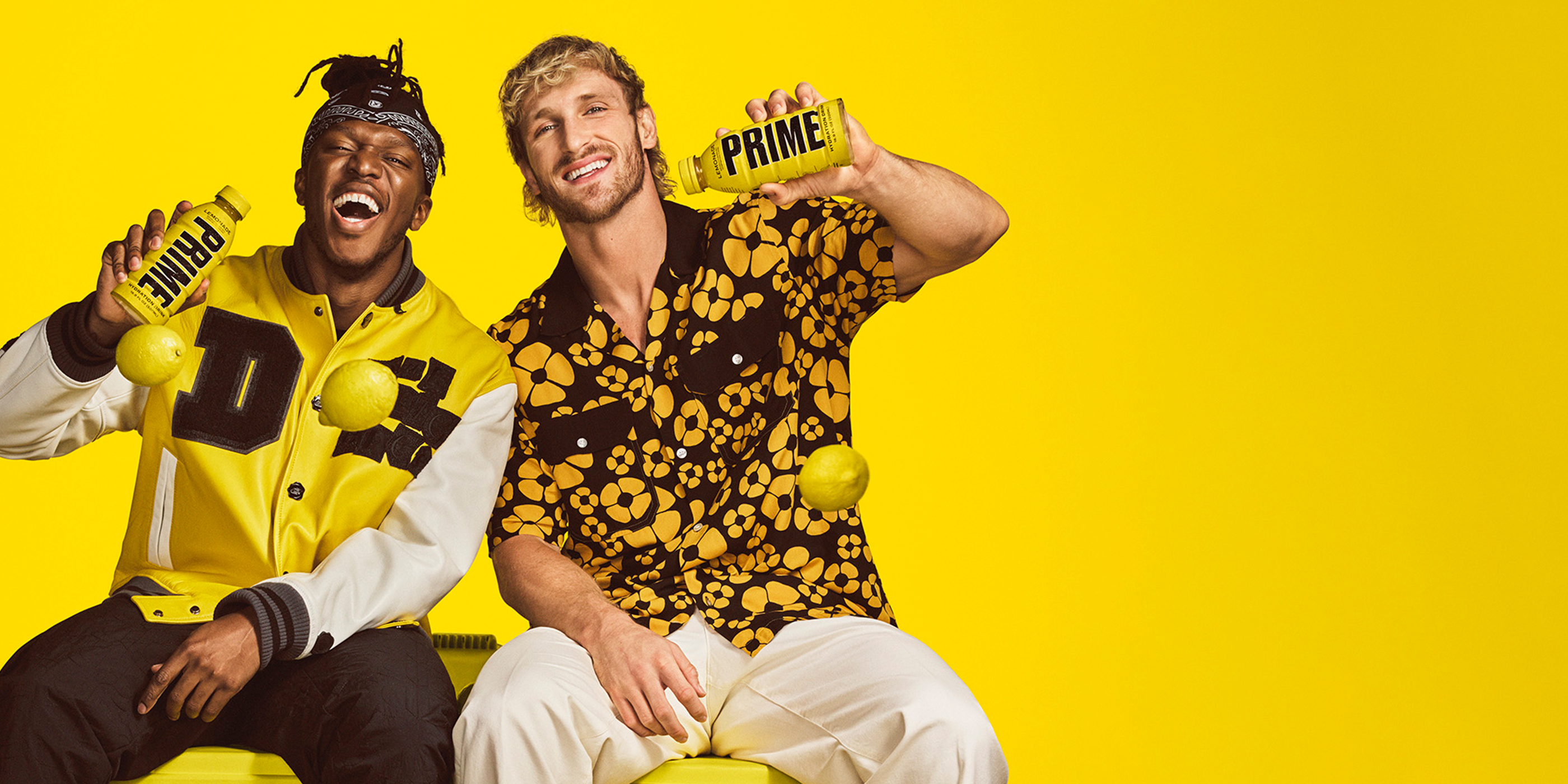 KSI and Logan Paul, each proudly displaying a Lemonade-flavored Prime hydration drink, adding to the lively atmosphere.