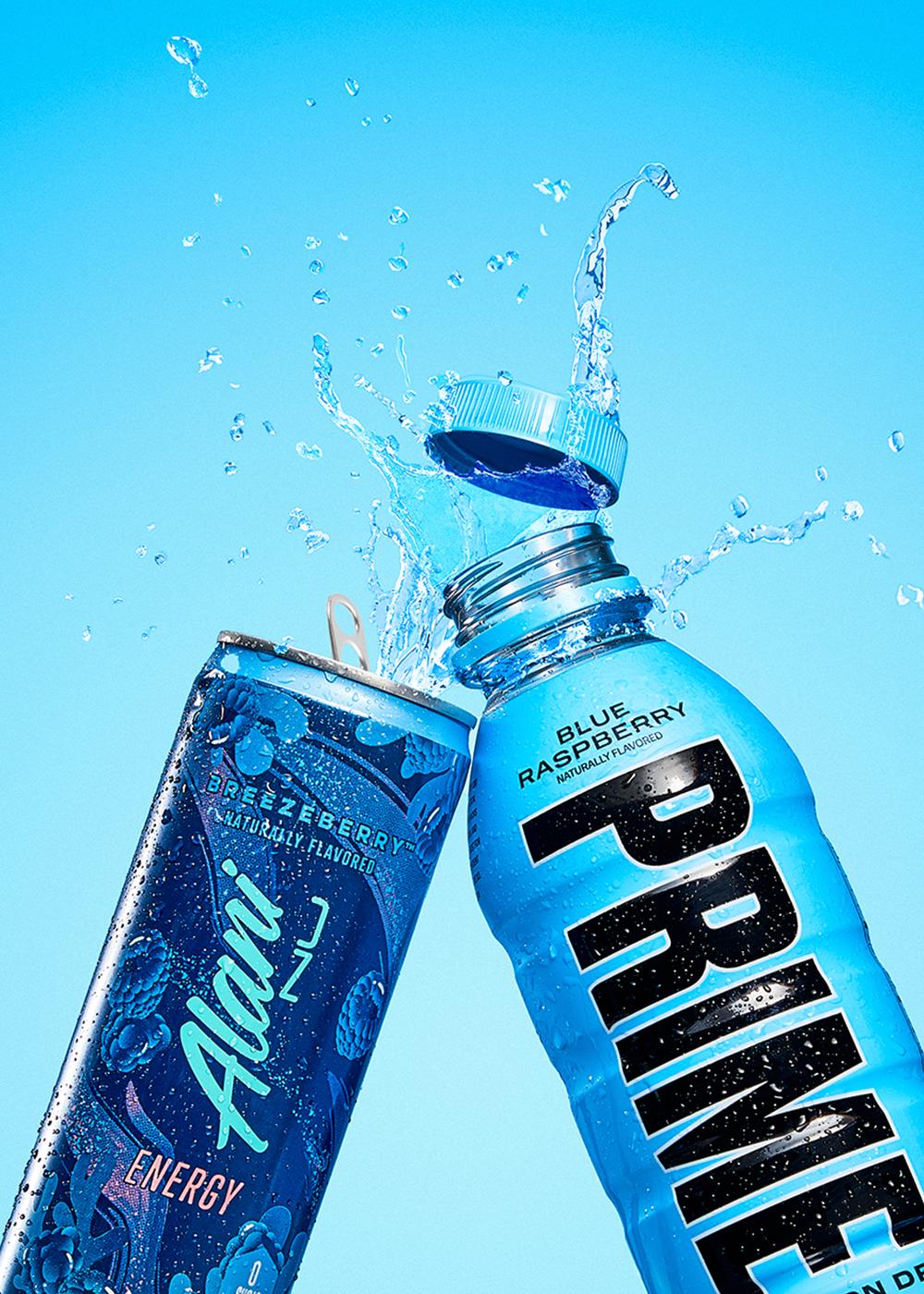 An energy drink in blue raspberry flavor splashing out of an open bottle next to a prime hydration bottle in blue raspberry flavor.