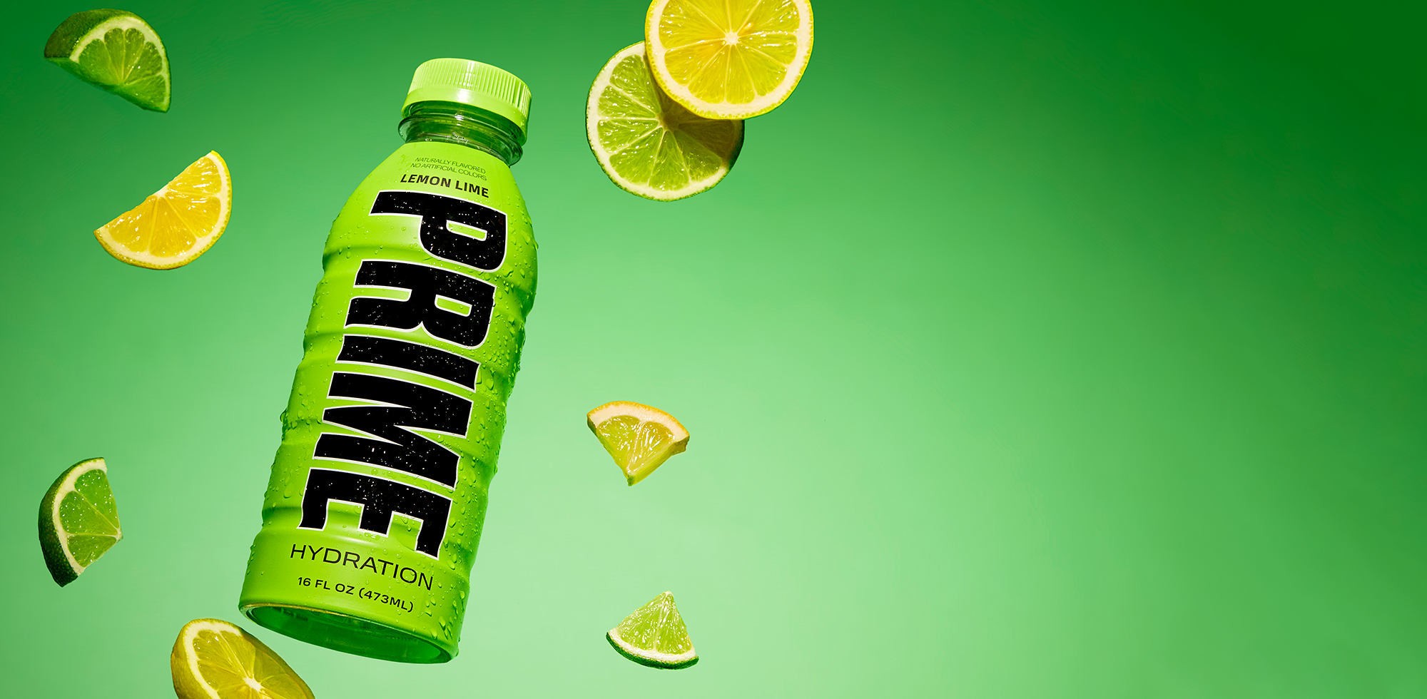 A green bottle of 'PRIME' hydration drink in lemon-lime flavor, surrounded by sliced citrus fruits, against a vivid lime green display.